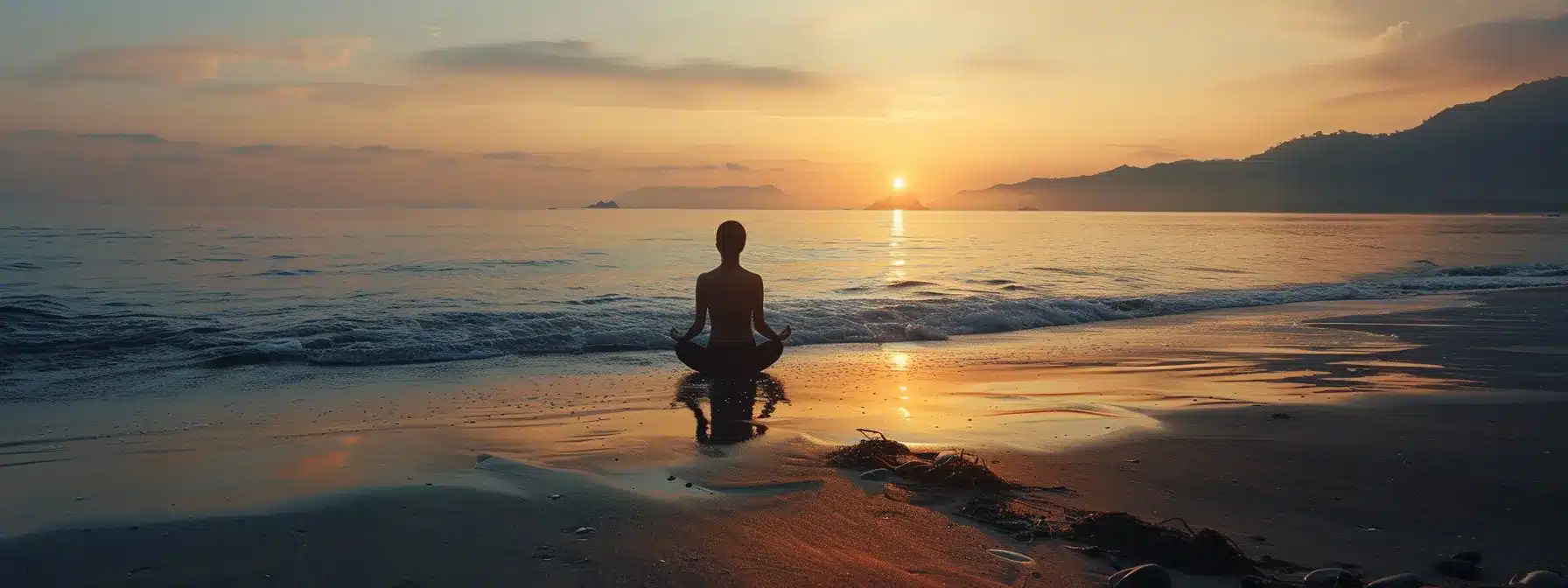 a serene sunset beach with a solitary figure practicing yoga, embodying peace and strength after rehab.