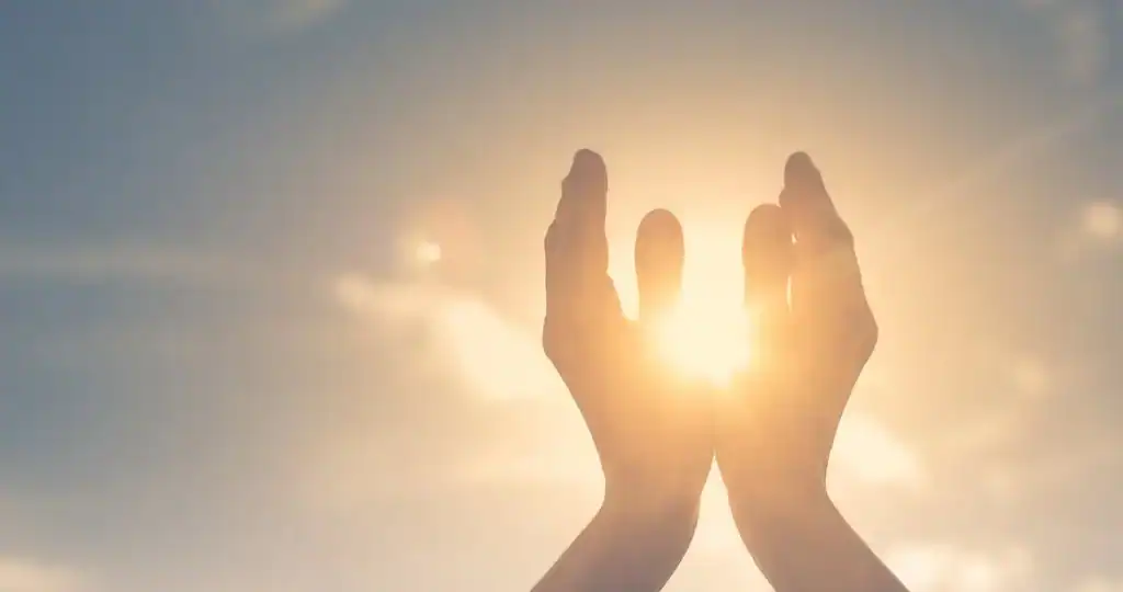 Hands reaching towards the sunlight symbolizing hope and recovery at a trusted addiction treatment center.