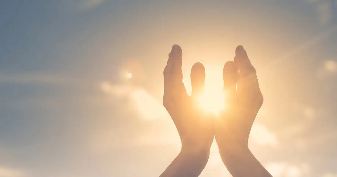 Hands reaching towards the sunlight symbolizing hope and recovery at a trusted addiction treatment center.