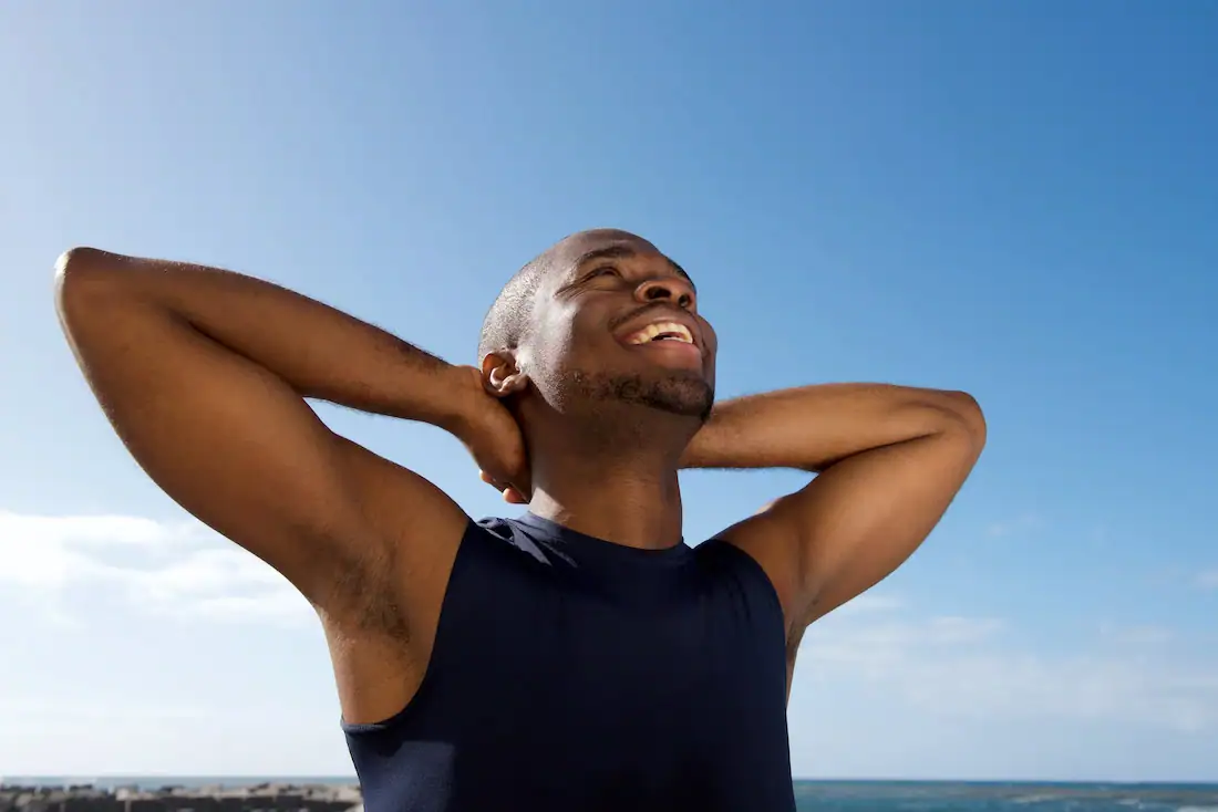 Peaceful man enjoying life at the beach after substance abuse treatment.