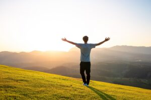 Man praising after discovering What Faith Can Do in Recovery.