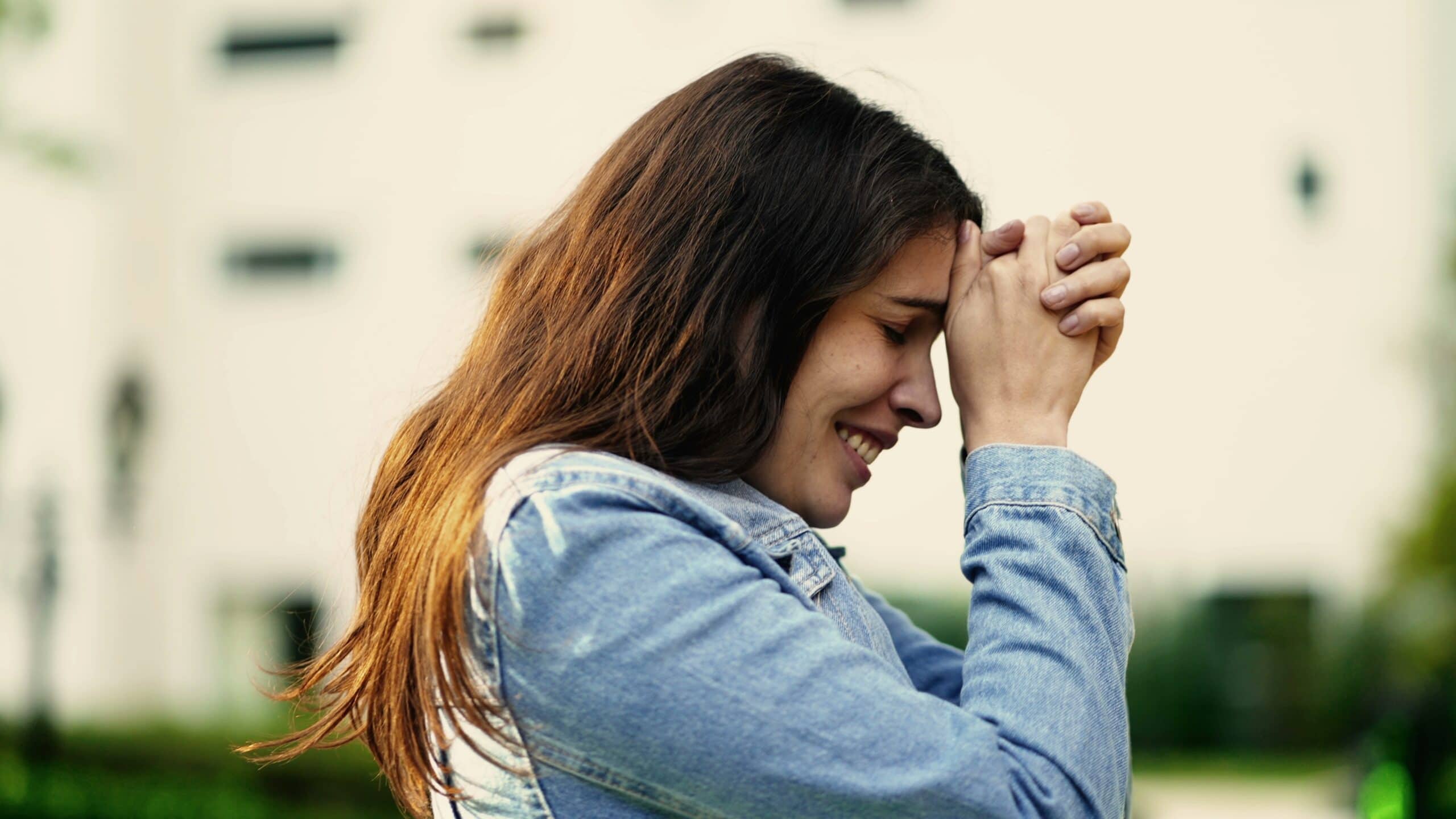 Woman praying after discovering What Faith Can Do in Recovery.