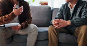 Two men talking about what are the 12 steps of addiction recovery​.